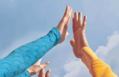 People raising hands together toward the sky, symbolizing collaboration, partnership, and shared progress in clinical research.