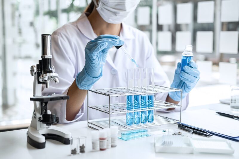 Scientist performing laboratory testing and sample analysis supporting clinical trials, biomarker testing, and clinical research data generation.
