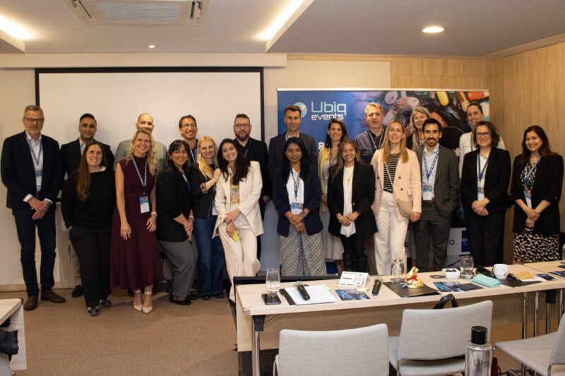Excelya team and event participants gathered in a conference room at UBIQ events